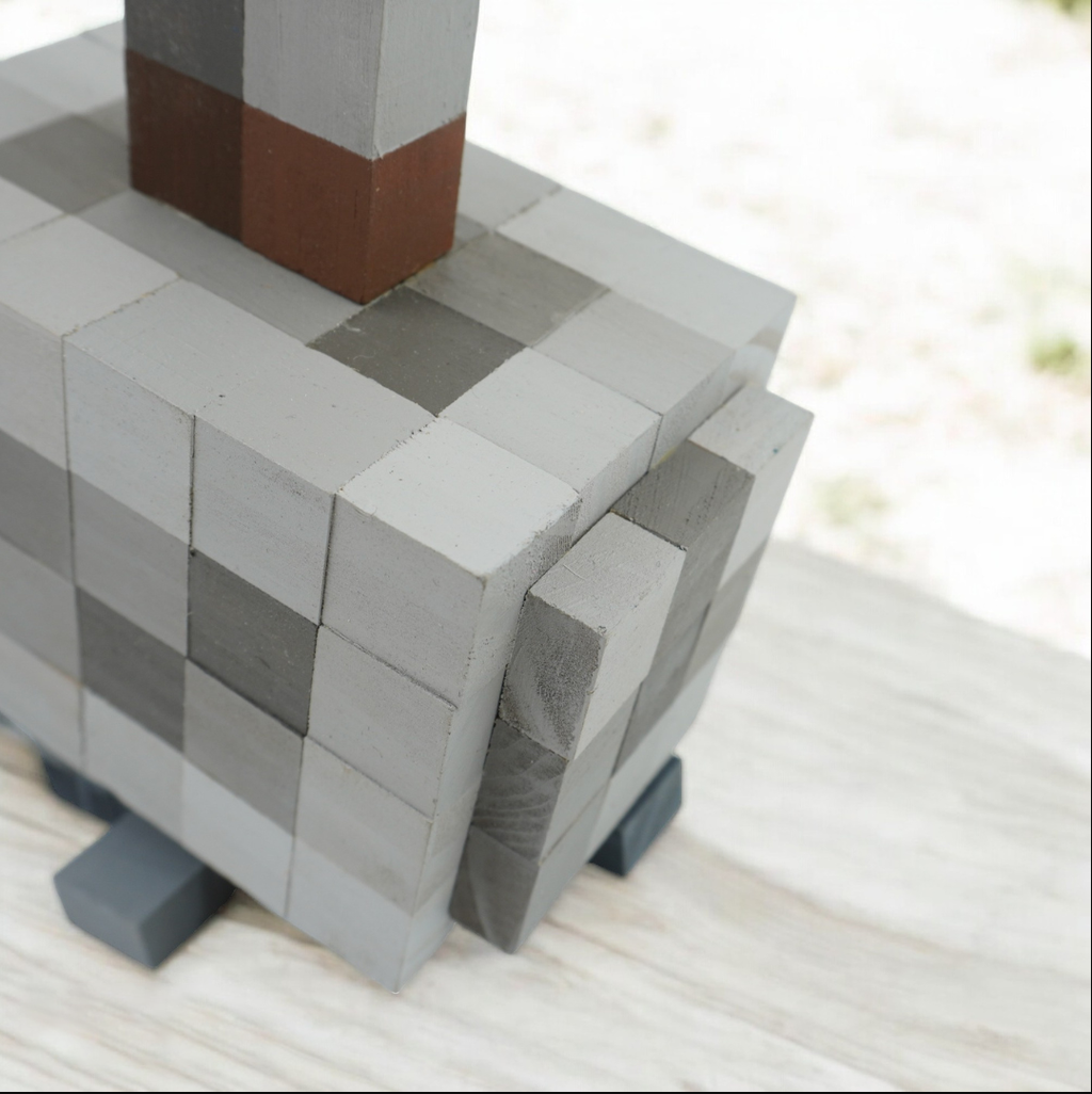 Close-up view of handmade wooden Minecraft Mjolnir hammer showing pixel block details.