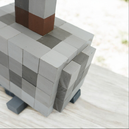 Close-up view of handmade wooden Minecraft Mjolnir hammer showing pixel block details.